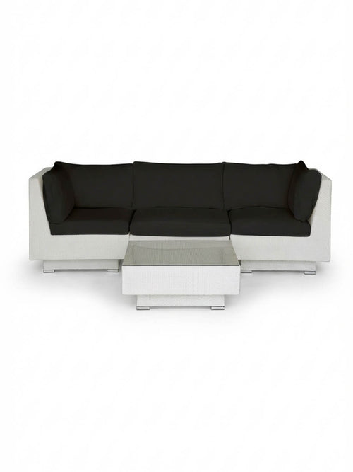 The Sereno White modular sectional sofa with black cushions and a matching rectangular coffee table is showcased on a plain white background, offering stylish outdoor lounge furniture.