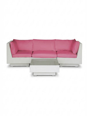 The Sereno White modular sofa features bright pink cushions and an L-shaped design, paired with a matching low rectangular white coffee table—ideal as stylish outdoor lounge furniture.