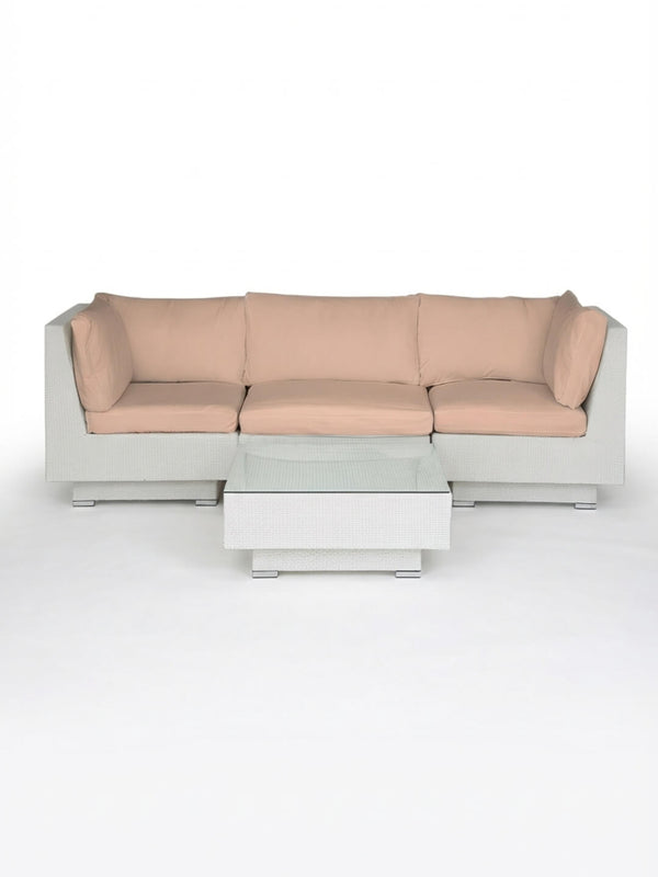 The Sereno White set includes a modern modular sofa with light beige cushions and a matching rectangular coffee table, both with white rattan frames—ideal for stylish outdoor entertaining against a plain white background.