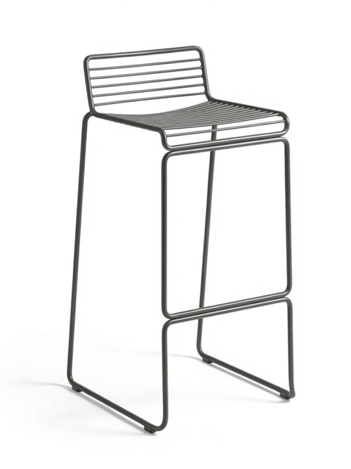 The Slate Bar Stool features a minimalist black metal wire frame with parallel rod seat and backrest, armless design, and straight sled legs for a sleek, modern look.