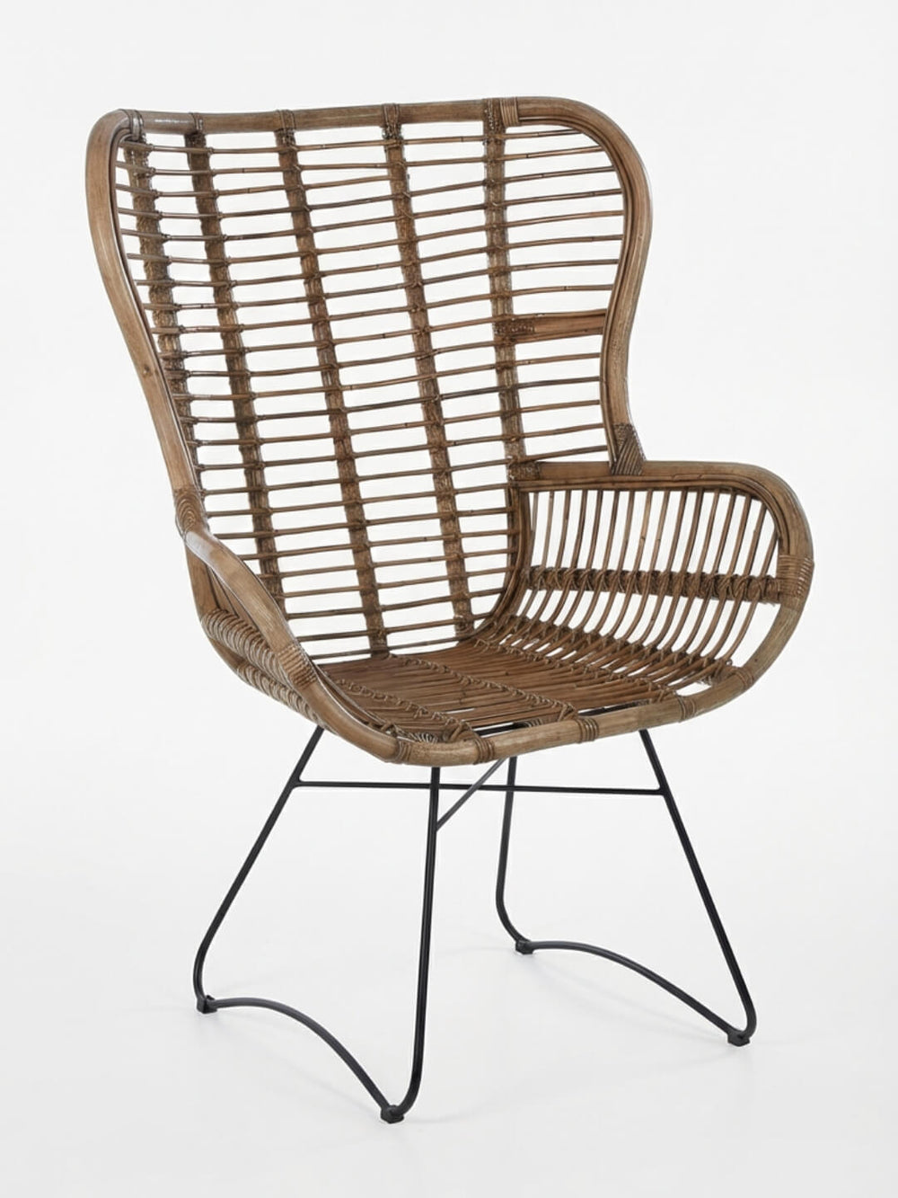 The Sundown Chair features a high back, natural cane design, wide armrests, and black metal legs—set against a white background, it’s the perfect bohemian accent chair for any space.