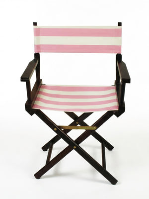 The Sunset Directors Chair features armrests and a pink and white striped canvas seat and backrest, all set on a wooden frame. Shown against a plain white background, it's a stylish outdoor director’s chair for any setting.