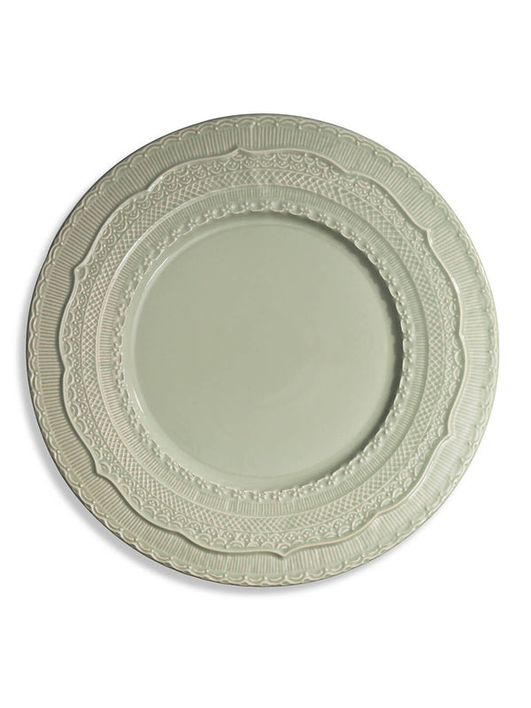 The Verdant Charger Plate is a round, light gray ceramic charger with an ornate, embossed rim featuring intricate scalloped and geometric designs. Its smooth center and elegant look make it perfect for garden weddings.