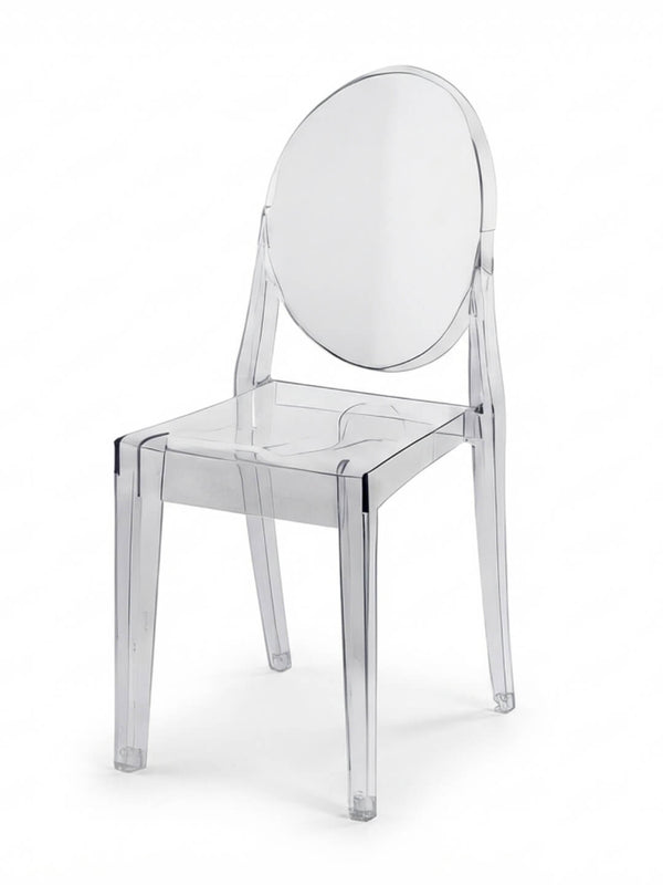 The Victoria Ghost Chair features a clear, modern design with a round backrest and straight legs, crafted from transparent acrylic—ideal as stylish event furniture.