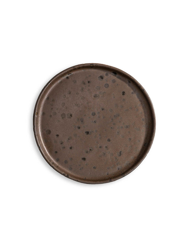 The Juniper Plate Range features a round, flat, dark brown ceramic plate with a slightly raised edge and speckled pattern—ideal as artisanal rustic wedding tableware—shown on a white background.