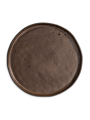 The Juniper Plate Range features large, oval ceramic plates with a smooth, dark brown, speckled surface. A subtle raised rim and uneven finish give each handcrafted piece an artisanal feel—ideal for rustic wedding tableware collections.