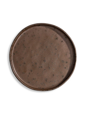 The Juniper Plate Range features four round, dark brown plates with a speckled finish and organic, irregular edges—beautifully handcrafted for stacking or display, ideal for adding unique character to any table setting.
