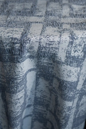 Table linen with textured geometric elegance in soft tones, bringing modern sophistication to refined table settings.