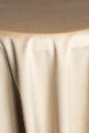 A Beige table linen with a luxurious texture that offers timeless elegance.