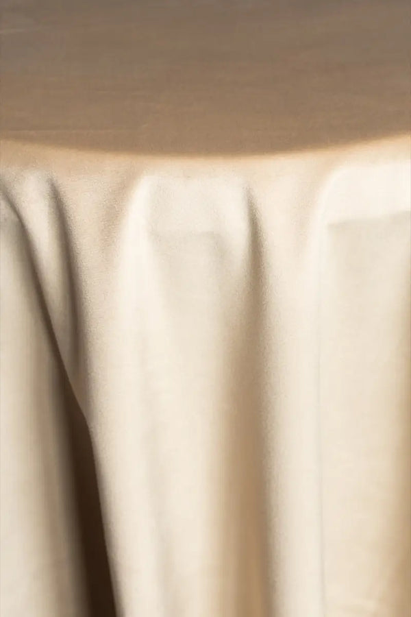 A Beige table linen with a luxurious texture that offers timeless elegance.