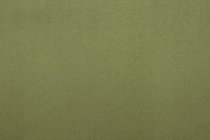 A Green table linen with a luxurious texture that offers timeless elegance.