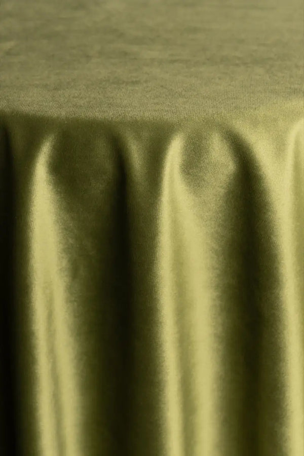 A Green table linen with a luxurious texture that offers timeless elegance.