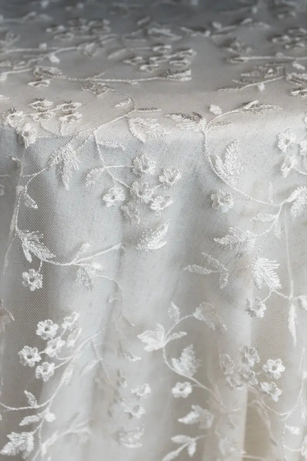 Table linen with lace overlay adding intricate texture and vintage charm to elegant, timeless tables.