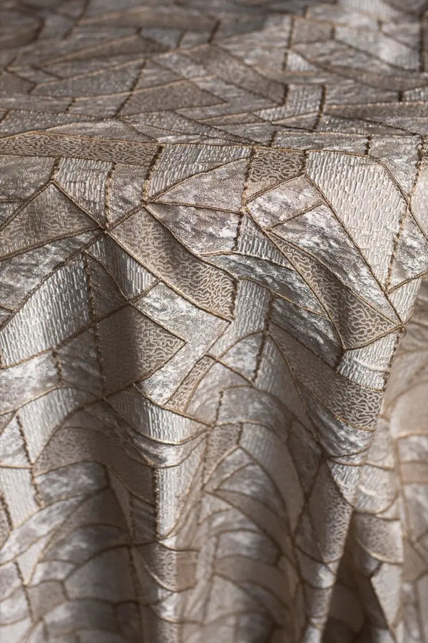 Table linen with shimmering geometric textures bring modern elegance and luxurious style to tables.