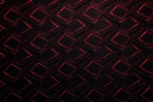 Table linen with rich red accents and bold geometric design create dramatic flair and luxurious style.