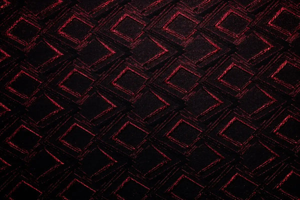 Table linen with rich red accents and bold geometric design create dramatic flair and luxurious style.