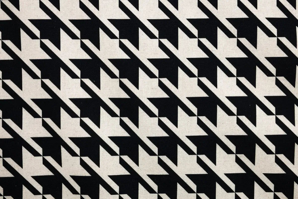 Table linen with classic black and white houndstooth brings timeless elegance and bold contrast to tables.