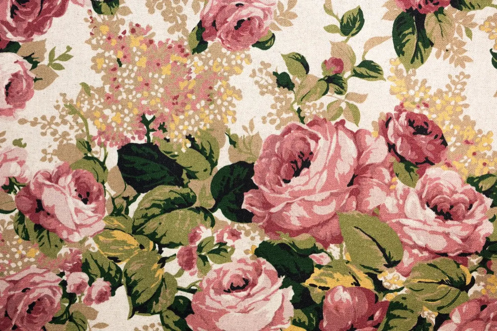 A table linen with lush pink blooms & verdant leaves providing classic sophistication and romantic charm.