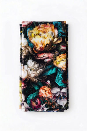 Valentina Linen features a vivid floral pattern with colorful flowers and green leaves on a crisp white background, making it the perfect choice for elegant, luxurious event decor.